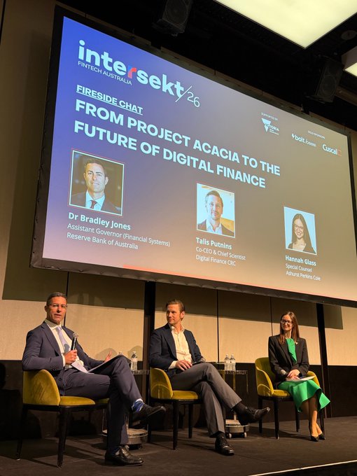 A panel discussion at Intersekt 26 FinTech Australia titled 'Fireside Chat: From Project Acacia to the Future of Digital Finance,' featuring Dr. Bradley Jones (Reserve Bank of Australia), Tālis Putniņš (Digital Finance CRC), and Hannah Glass (Ashurst).