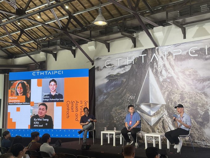 Three speakers are seated on stage at ETHTaipei, with a screen displaying "Ko-Wei Tseng, APEX" and a backdrop featuring the ETHTaipei logo alongside a large Ethereum symbol. The image visually aligns with the post's description, capturing Ko-Wei Tseng on stage discussing private vs. public chains and institutional decision axes.