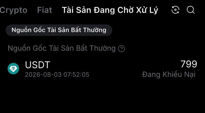 A Vietnamese-language crypto app screen showing 'Tài Sản Đang Chờ Xử Lý' (Pending Assets) with 799 USDT dated 2026-08-03 marked as 'Đang Khiếu Nại' (Disputing).