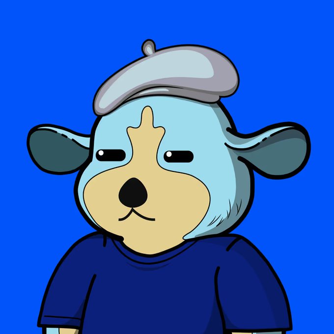 A cartoon dog character with a blue face, tan snout, and a blue beret wears a dark blue shirt against a solid blue background.