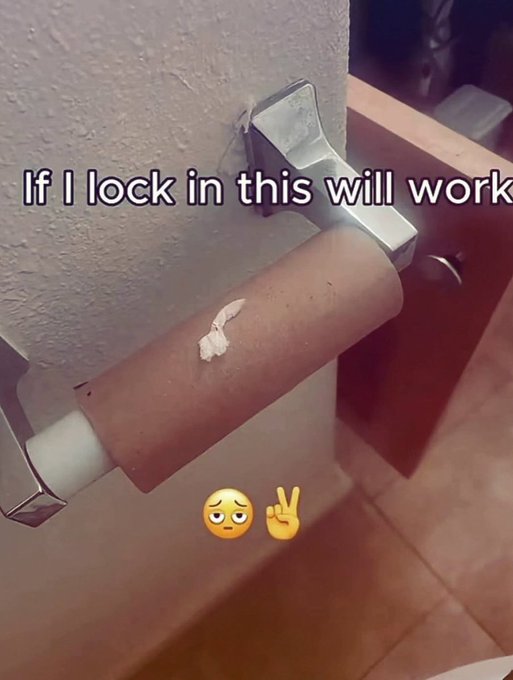A photo of a brown toilet paper holder mounted on a wall with the overlaid text 'If I lock in this will work' and pleading face and peace sign emojis.