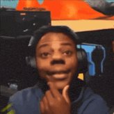 The image features a man wearing headphones with his chin resting on his hand while making a funny face for the camera. The background includes an orange object that appears to be a speaker or amplifier, suggesting that this scene might be taking place at a gaming event or a similar gathering where audio equipment is being used.

The caption of the image reads "just casually hosting 2k+ events like it's no big deal, wait till they hit 10k". This implies that the man in the picture could be participating in an event related to video games or multimedia, and he might be making a funny face for the camera as part of his performance.