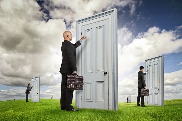 A businessman knocks on a giant door in an open field, with other figures doing the same on smaller doors in the background, visually illustrating the post's metaphor about ICP's unconventional "door-to-door" approach to selling cloud engines, waiting for interested buyers to ask about pricing before quoting a cost.