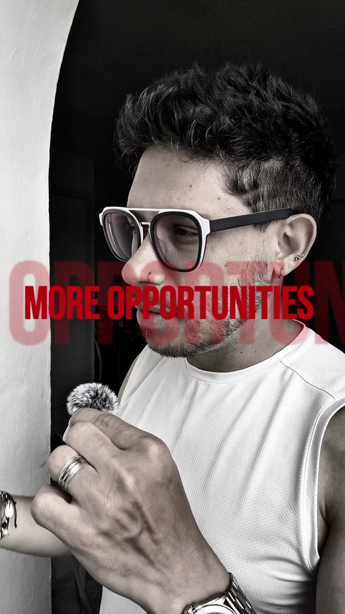 A black-and-white portrait of a man wearing white-rimmed sunglasses and holding a small microphone, with the bold red text "MORE OPPORTUNITIES" overlaid across the image—suggesting his message about $DMTR's 150% price surge points to growing prospects for the token.