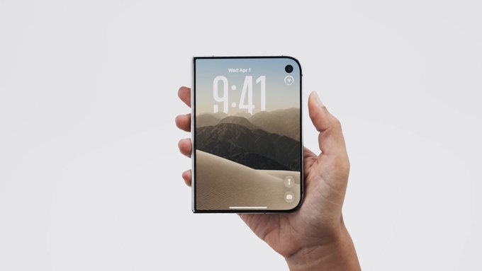 A hand holds a modern smartphone displaying a lock screen with the time '9:41' and date 'Wed Apr 1' against a desert background.