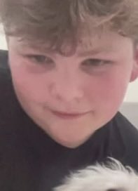 A young person with light brown, tousled hair and flushed cheeks takes a close-up selfie while wearing a dark shirt. The caption references this individual, known online as "Quant Kid," claiming he revealed he profited $50,000 trading Bitcoin with 50x leverage, with the image likely serving as his profile photo.