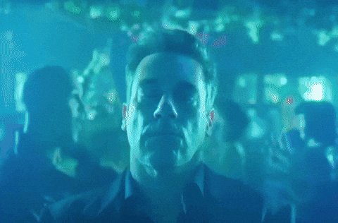 iced tea with a straw, a man's face, and blurred figures of people are present in the scene.