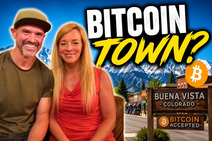 A YouTube thumbnail featuring a smiling couple with the bold text 'BITCOIN TOWN?' alongside a sign reading 'BUENA VISTA COLORADO BITCOIN ACCEPTED' over a mountain town backdrop.