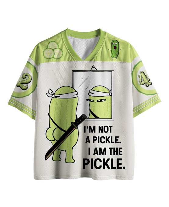 A green and white sports jersey features cartoon pickles—one wearing a ninja headband holding a katana in front of a mirror—with the text 'I'M NOT A PICKLE. I AM THE PICKLE.'