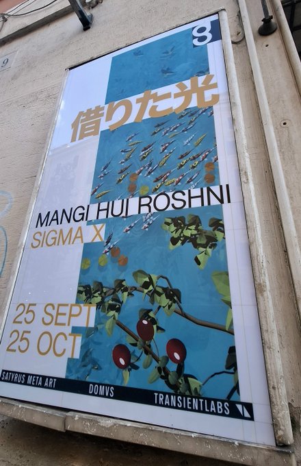 An outdoor poster advertising an art exhibition titled 'MANGI HUI ROSHNI' by 'SIGMA X', showing dates '25 SEPT' to '25 OCT' with artwork depicting fish and fruits, and labels for 'SATYRUS META ART', 'DOMVS', and 'TRANSIENTLABS'.