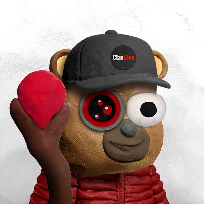 A claymation teddy bear wearing a black "ClayStop" cap holds a red heart-shaped object, with one robotic-looking red eye, humorously portrayed as the whimsical mascot offering a tiny $3.47 credit for charity.