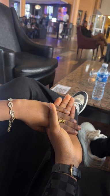 A relaxed moment at the Solana Summit is captured as two friends hold hands in a lounge, with one wearing a gold ring and a diamond-encrusted infinity bracelet, while the other sports a black watch — perfectly mirroring the caption's sentiment of reconnecting IRL with longtime online "moots."