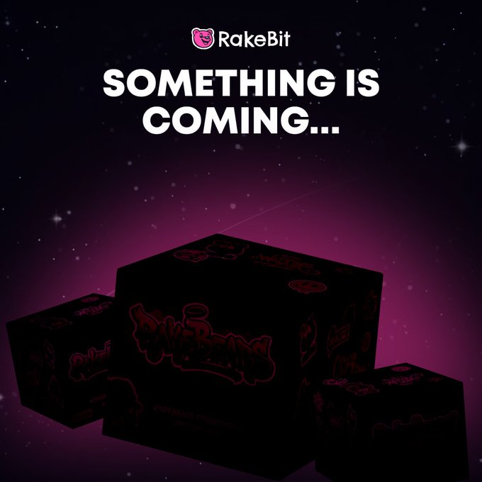 Teaser image with the RakeBit logo and text "SOMETHING IS COMING..." displaying three dark gift boxes with red graffiti designs against a starry purple background.