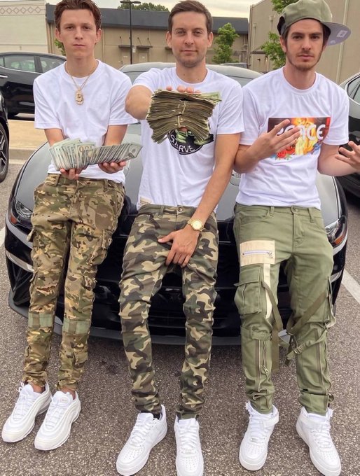 Three young men in matching white tees and camo cargo pants pose in front of a sleek sports car, each flashing thick stacks of cash to flaunt their crypto-fueled wealth. The caption references $Stonk, $paid, and $Tobey as meme coins, framing the trio's bold, money-wielding stance as a tongue-in-cheek comeback for "real" memecoin culture.