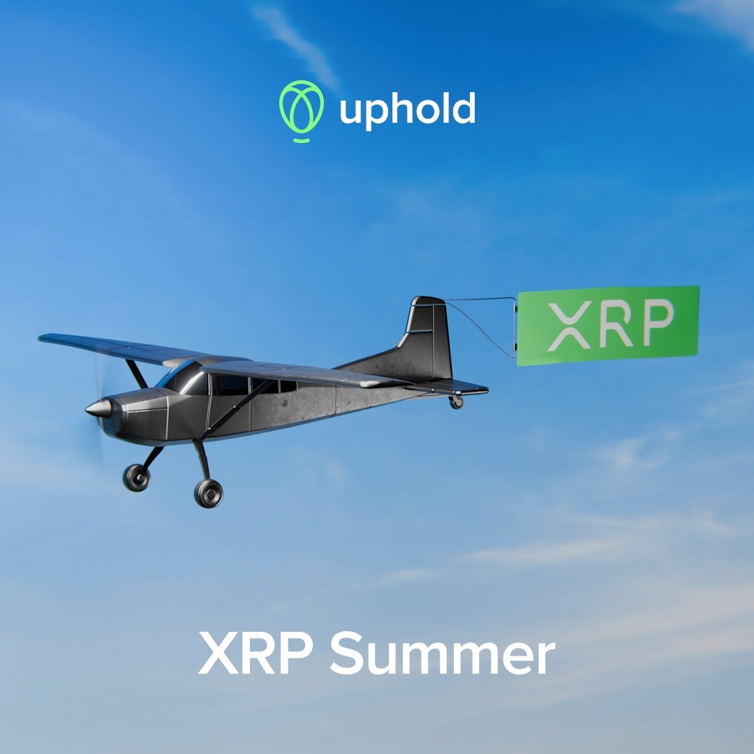 A black small plane flies through a blue sky, towing a green banner that reads "XRP," with the "uphold" logo displayed above and the text "XRP Summer" written below, visually reinforcing the "It's XRP Summer" sentiment by depicting XRP taking flight.
