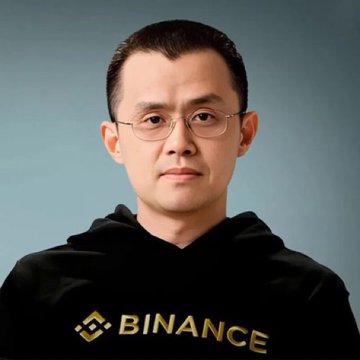 The image shows a man with short dark hair and glasses wearing a black Binance hoodie, likely Changpeng "CZ" Zhao. The caption relates to the post about the Binance founder hinting at an imminent crypto rally, with his recognizable logo visible on his attire.