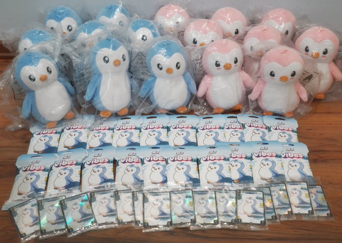 A collection of Pudgy Penguins plush toys (in blue and pink) and "Target Vibes" TCG packs with penguin card designs, displayed in their plastic packaging. The image accompanies a thank-you message praising a friend who carried these collectibles from the US to Malaysia, connecting the merchandise shown directly to the heartfelt appreciation expressed in the post.