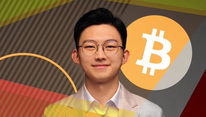The image features a young man with glasses in a beige blazer, positioned next to a large orange Bitcoin (₿) logo against a geometric background. The "BULLISH" caption aligns with the CryptoQuant CEO's prediction of an upcoming major bullish phase for Bitcoin in the coming months.