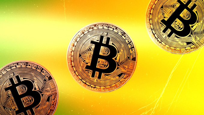 Three gold Bitcoin coins with the iconic "₿" symbol are displayed against a vibrant yellow-orange gradient background, visually reinforcing the post's message of Bitcoin's strong quarterly performance. The coins feature visible inscriptions including "DIGITAL," "DECENTRALIZED," and "PEER TO PEER," symbolizing the cryptocurrency's fundamental characteristics as $BTC surges more than 40% in Q3.
