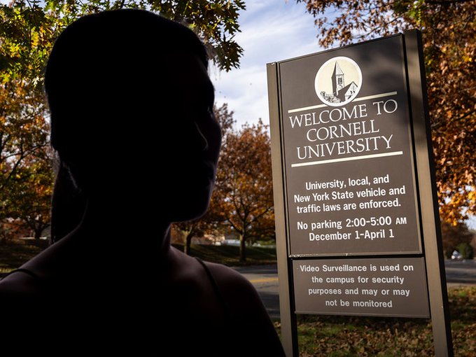 A silhouetted figure stands in front of a Cornell University welcome sign, which notes that "No parking 2:00-5:00 AM December 1-April 1" and warns that "Video Surveillance is used on the campus for security purposes."

The image's connection to the accompanying post appears to be a reference to a recent legal case involving students at Cornell University, paralleling the Duke Lacrosse incident, where young men's lives have been upended by serious allegations.