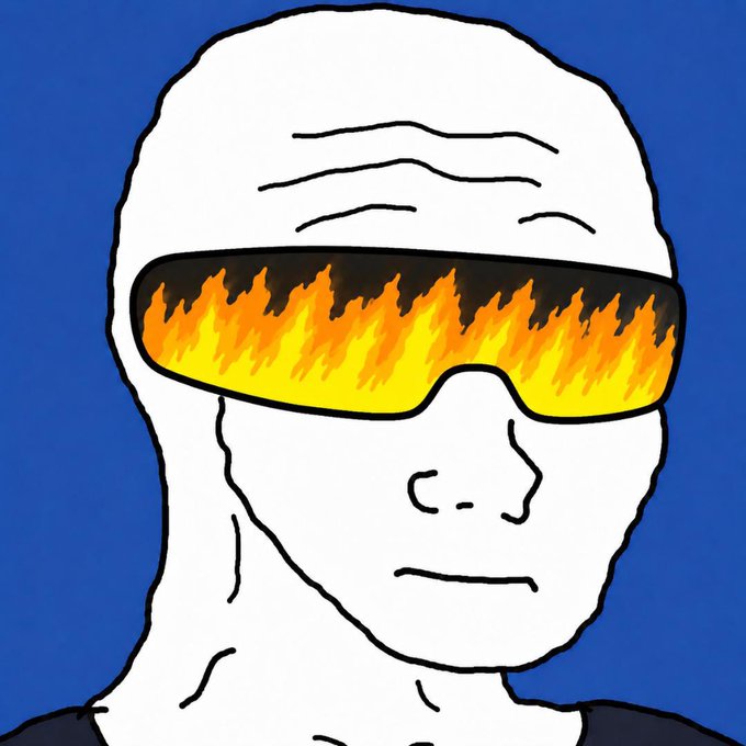 The image features a white man wearing glasses with orange flames painted on them, set against a blue background. The man's face is the main focus of the image, and he appears to be looking down at something or someone. The caption below the image reads "$WOJAK 10b+".