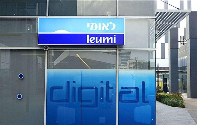 The image shows the exterior of a Bank Leumi ("leumi" in English, "לאומי" in Hebrew) branch, with a blue "digital" sign on the glass facade, visually representing the bank's digital banking initiative that the post describes as expanding into cryptocurrency trading through its partnership with Galaxy Digital.