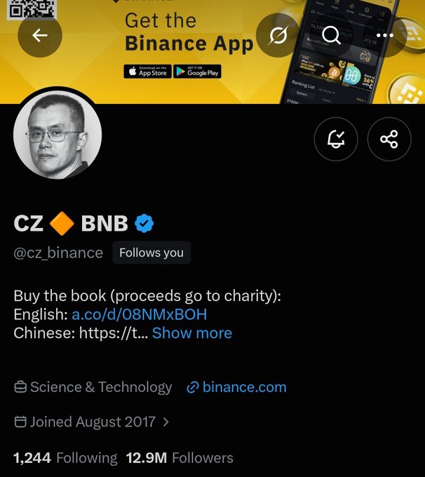 A Twitter/X profile for 'CZ' (@cz_binance) with a verified BNB checkmark, promoting his book with charity proceeds and linking to Binance, having joined August 2017 with 12.9M followers.