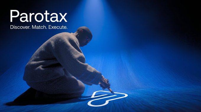 A person in a gray sweater kneels on a blue-lit floor, drawing glowing white lines on the ground with their finger, with the text "Parotax - Discover. Match. Execute." displayed in the upper left corner, visually representing the AI capability network's tagline of discovering, matching, and routing autonomous agents as mentioned in the post about $PTX.
