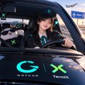 A small image showing a person inside a vehicle marked with 'GX' and 'Taiko' logos, with X-shaped targeting markers overlaid.