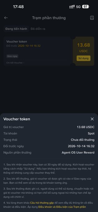 A mobile app screen in Vietnamese titled 'Trạm phần thưởng' displays a 'Voucher token' valued at 13.68 USDC, showing an expected date of 2026-10-14 and rules for receiving monthly agent rewards.