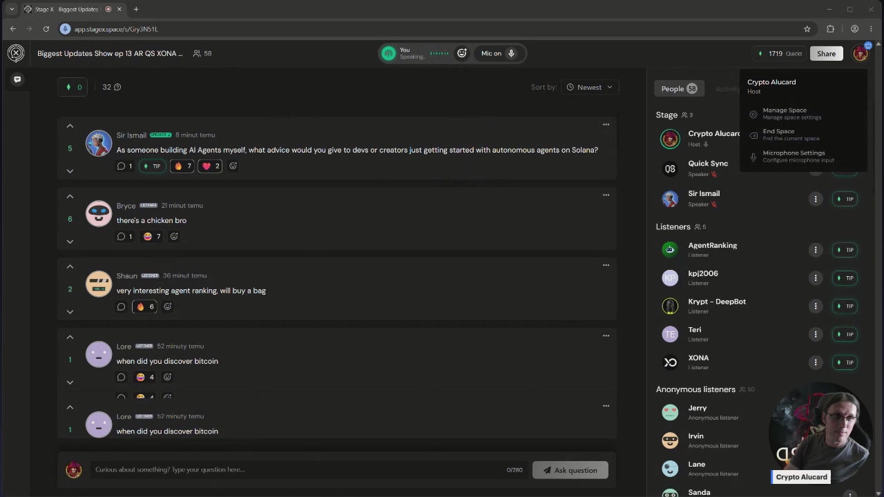 The image shows a computer screen displaying a chat window with multiple people participating in a conversation, including a man wearing glasses who appears to be talking about a recent update or event. The chat window has a green background that stands out against the black screen. The text on the screen reads "Biggest Updates Show ep. 13 $AR $QS $XONA $OOBE Sir Ismail". This information suggests that there might have been an important announcement, update, or discussion related to a specific event or topic of interest for those involved in the conversation.