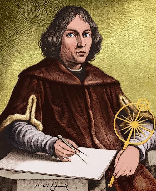 The image is a color illustration depicting Nicolaus Copernicus, recognizable by his shoulder-length brown hair and brown scholar's robe with fur trim, seated at a wooden desk holding a compass over parchment while a golden armillary sphere rests beside him.

The post references Copernicus's birthplace in Poland and draws a parallel between his heliocentric revolution and Bitcoin's "power law," noting his lesser-known economic contributions—fittingly mirrored in the image by the astronomical and mathematical instruments that symbolize both his celestial discoveries and quantitative work.