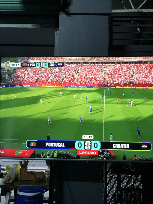 A TV screen showing a live UEFA Euro soccer match between Portugal and Croatia with a 0-0 score at 10:17, displayed on a Lenovo monitor in what appears to be a stadium viewing area.