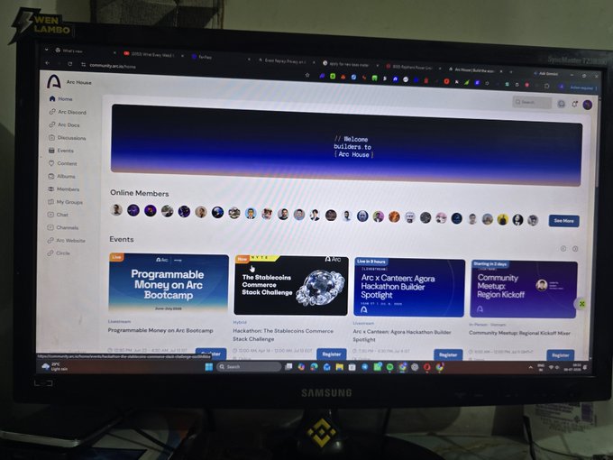 A Samsung computer monitor displaying the Arc House community webpage on community.arcadia.com, showing a welcome banner for builders, online member avatars, and event listings like "Programmable Money on Arc Bootcamp" and "Hackathon: The Stablecoins Commerce Stack Challenge".
