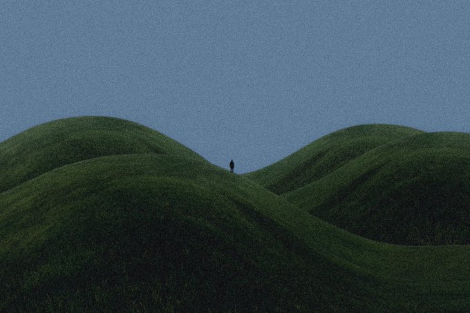 A minimalist landscape photograph shows a small silhouetted figure standing between rolling green hills beneath a muted blue sky.