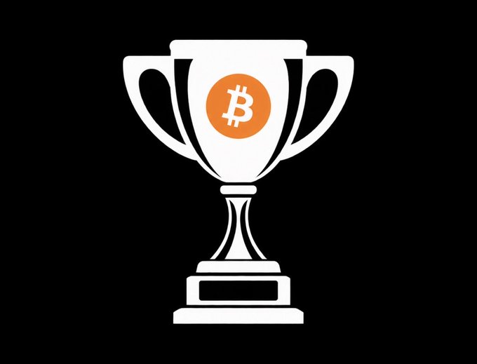 A white trophy against a black background features an orange Bitcoin "₿" emblem on its bowl, symbolizing the winners of the Kinetic Finance × Roxom giveaway. The trophy represents the $SATA and $STRC prizes awarded to @journeyofchandu and @kwinkys.