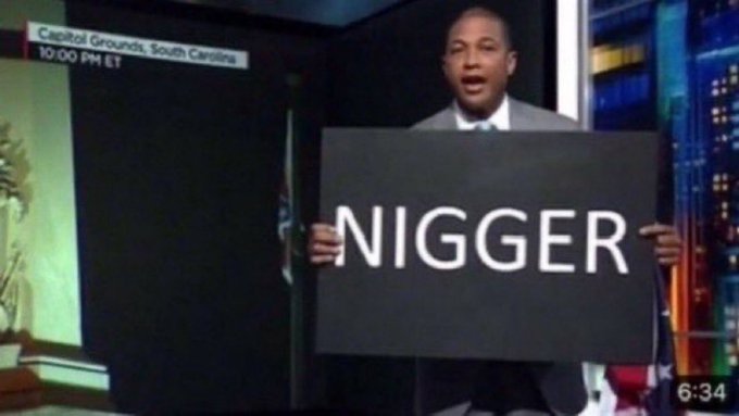 The image shows a man holding up a sign with the word "nigger" written on it, as if protesting or making a statement against racism or discrimination related to African Americans. The sign is black and features white text. The caption of the image reads: "buying $ZEC at $615 is like buying $BTC at $615".