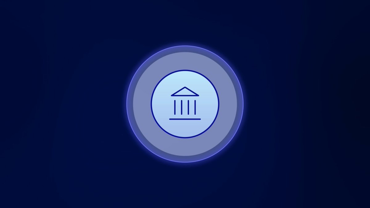 This is a blue logo design with a white building, possibly representing a bank or financial institution, set within an outer circle. The phrase "The Prividium Difference Privacy & Compliance are not opposites" is written at the bottom of the image. This quote appears to be related to the image and could provide context about the design or its purpose.
