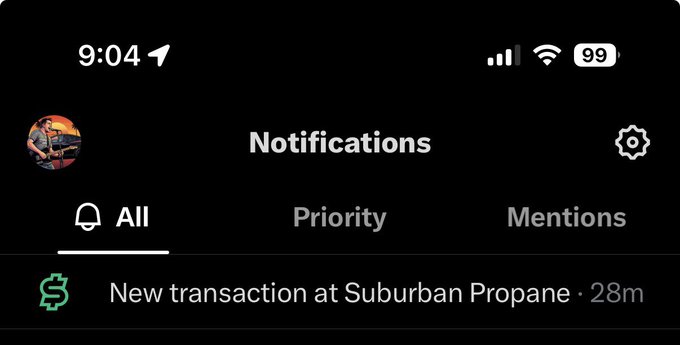A smartphone notifications screen displays "9:04" with a full battery at 99% and shows a new transaction alert from "Suburban Propane" from 28 minutes ago, illustrating the user's progress in transitioning their recurring utility payments to X Money.