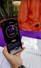 The image shows a person holding a smartphone displaying the Pi Network app interface, while seated at a table with a registration or attendance form, illustrating community member onboarding efforts in Laos.

A person holds a phone displaying the Pi Network app at a registration table, reflecting the Pi community engagement efforts being highlighted in Laos.