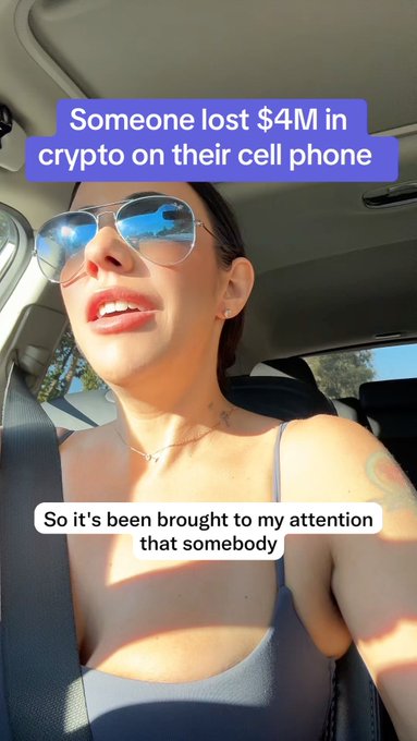 A woman wearing aviator sunglasses speaks from inside a car, with on-screen text reading "Someone lost $4M in crypto on their cell phone" at the top and "So it's been brought to my attention that somebody" below. The post's skeptical question about people storing crypto on phones directly relates to the alarming claim of a $4 million loss, prompting her reaction to the news.