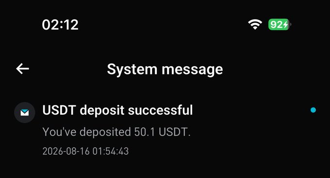 A smartphone screen displays a system message confirming a successful USDT deposit of 50.1 USDT, timestamped 2026-08-16 01:54:43, with the battery at 92% at 2:12 AM—evidencing the late-night crypto hustle referenced in the post.