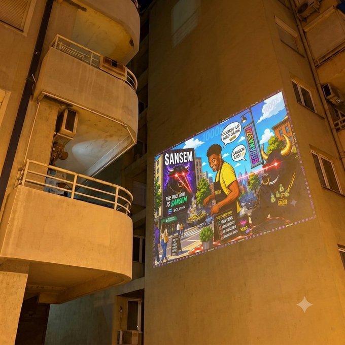 A nighttime building projection meme featuring 'ANSEM' as a comic-book-style character with a bull and 'SANSEM' branding, including text like 'COMIN UP BAD PAINS' and 'SANSEM VIBES'.