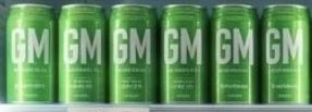 Six green beverage cans lined up in a row, each prominently displaying the white letters "GM," which stands for "Good Morning" in Web3 culture, aligning with the post's message of consistent daily effort and progress.