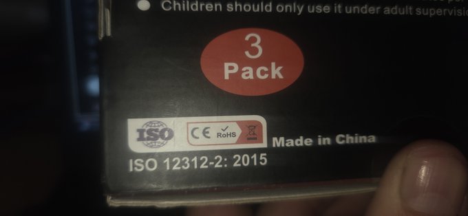 A close-up image shows a black product package labeled "3 Pack" with certification markings including "ISO 12312-2: 2015," "CE," and "RoHS," along with the text "Made in China," partially held by a hand. The top of the package includes a safety warning that children should only use it under adult supervision.
