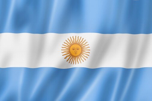 The image is the flag of Argentina, which is relevant to the post about Messi and the XRP cryptocurrency. The post suggests a conspiracy linking Argentina's performance with the crash of XRP.