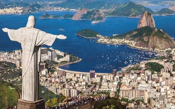 A composite image featuring the Christ the Redeemer statue overlooking Rio de Janeiro, Brazil, with Sugarloaf Mountain and Guanabara Bay visible in the background.