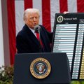 Former President Donald Trump speaks at a podium bearing the presidential seal during an event, with a sign behind him referencing "OPERATION MIDNIGHT HAMMER."