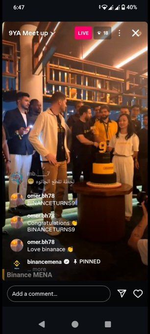 A screenshot of an Instagram live stream titled '9YA Meetup' showing a group of people at an event with a Binance-branded '9' cake, featuring comments like 'Congratulations BINANCETURNS9'.