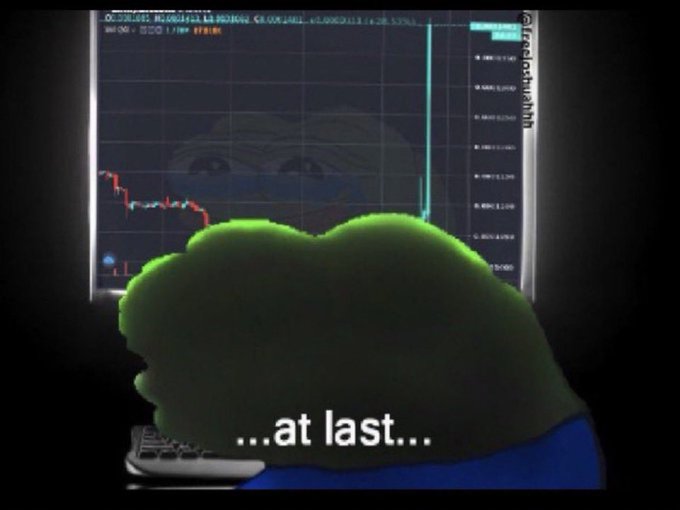 A meme image showing a green Pepe-style frog character from behind looking at a computer screen displaying a trading chart with a sudden vertical green spike, with the caption '...at last...' suggesting a long-awaited price breakout.